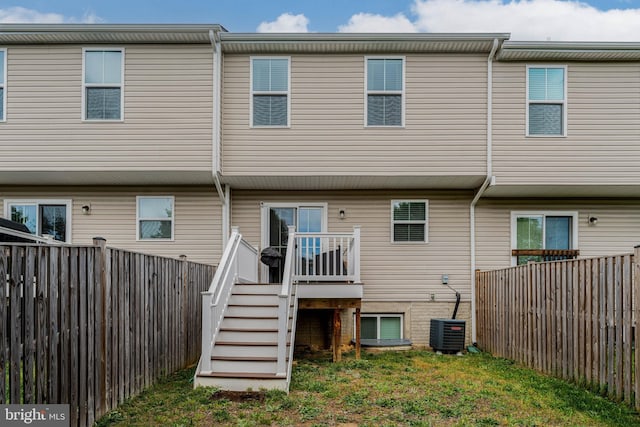 back of house featuring stairs, a fenced backyard, a deck, and cooling unit