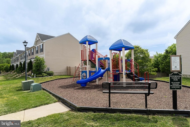 community jungle gym with a lawn