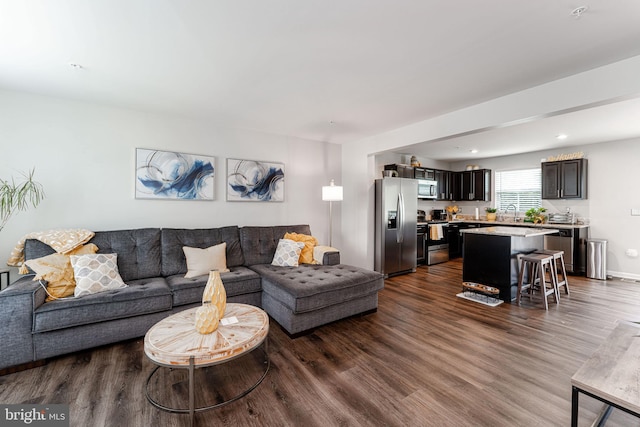 living room featuring dark wood-style flooring and recessed lighting