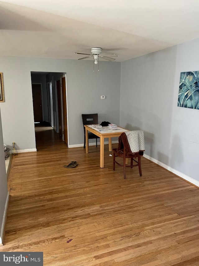 dining room with baseboards, ceiling fan, and light wood-type flooring