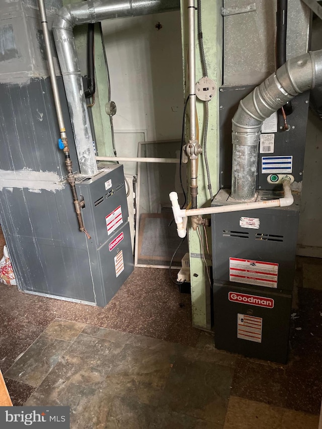 utility room featuring heating unit