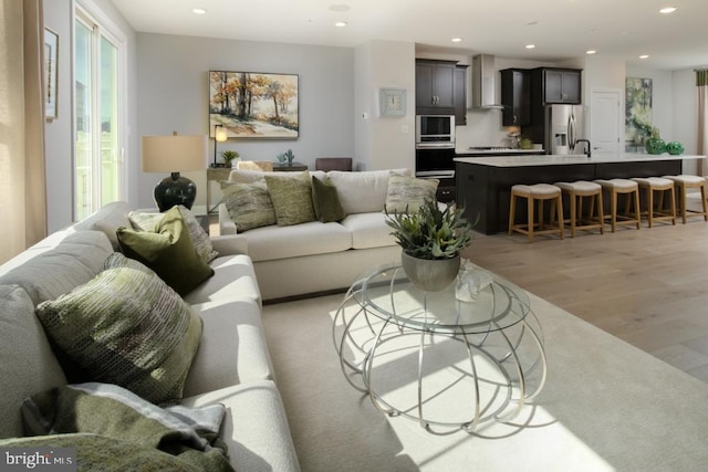 living room with recessed lighting and light wood finished floors
