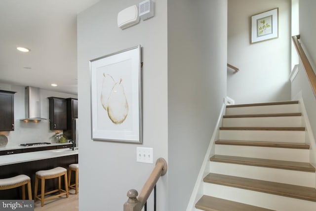 staircase featuring recessed lighting and wood finished floors
