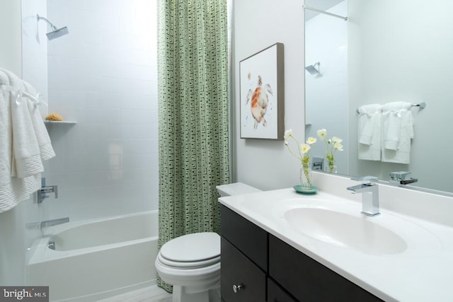 bathroom featuring vanity, shower / bath combo, and toilet