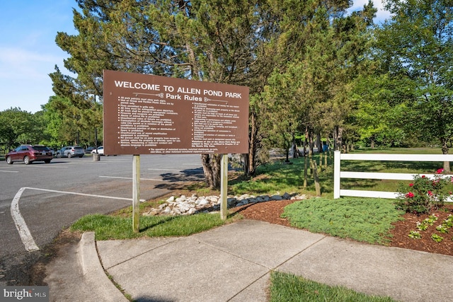 exterior details featuring a parking lot and fence