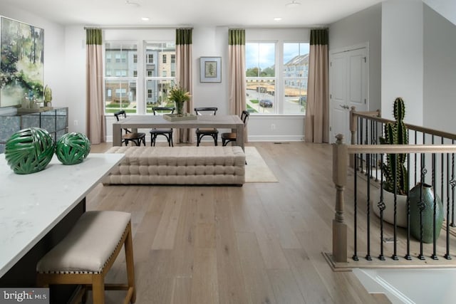 dining area with recessed lighting, baseboards, and light wood-type flooring