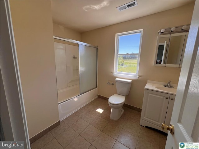 bathroom featuring visible vents, vanity, tile patterned floors, baseboards, and toilet