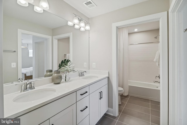 bathroom with visible vents, a sink, tile patterned floors, and toilet