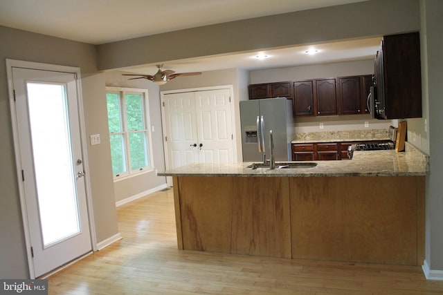 109 Hamlin Dr, Fredericksburg, VA 22405 - kitchen with stainless steel fridge, a sink, light wood-style floors, a peninsula, and recessed lighting