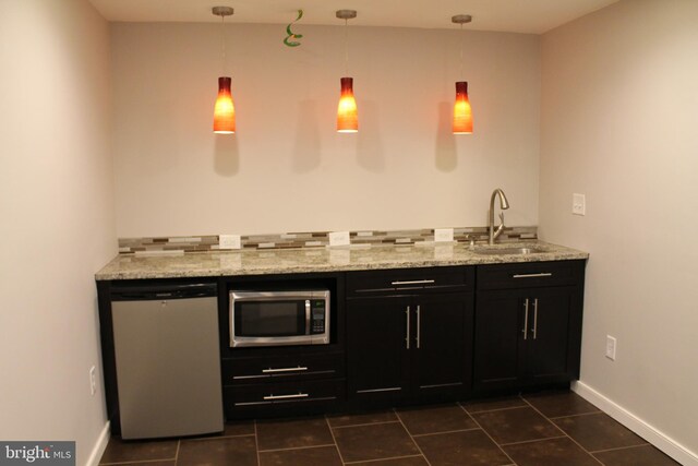 109 Hamlin Dr, Fredericksburg, VA 22405 - bar area with stainless steel microwave, a sink, fridge, dark tile patterned flooring, and pendant lighting