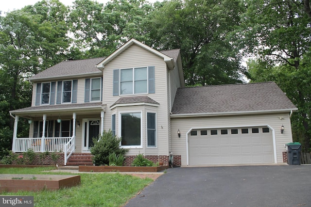 109 Hamlin Dr, Fredericksburg, VA 22405 - view of front of home featuring asphalt driveway, an attached garage, a porch, and roof with shingles