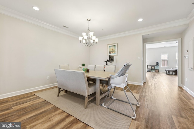 207 Community Center Ave Unit 207, Gaithersburg, MD 20878 - dining room with baseboards, ornamental molding, wood finished floors, and a notable chandelier