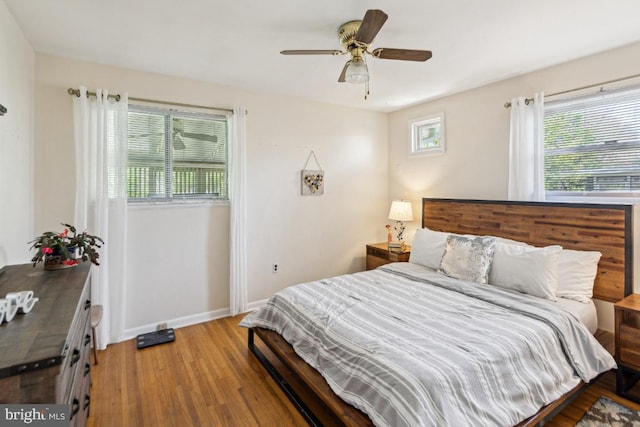 bedroom featuring light wood-type flooring, baseboards, and ceiling fan