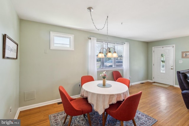 dining room featuring a healthy amount of sunlight, baseboards, and light wood-style floors
