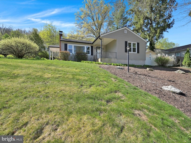ranch-style house with a chimney and a front yard