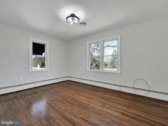 spare room with visible vents and wood finished floors