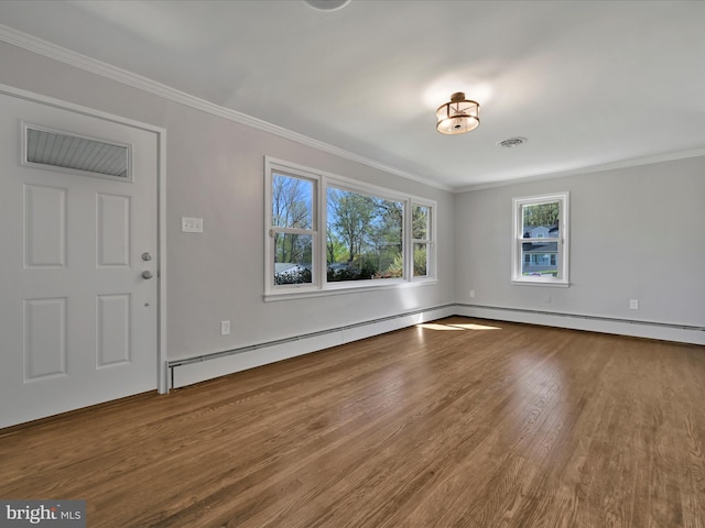 unfurnished living room featuring baseboards, ornamental molding, and wood finished floors