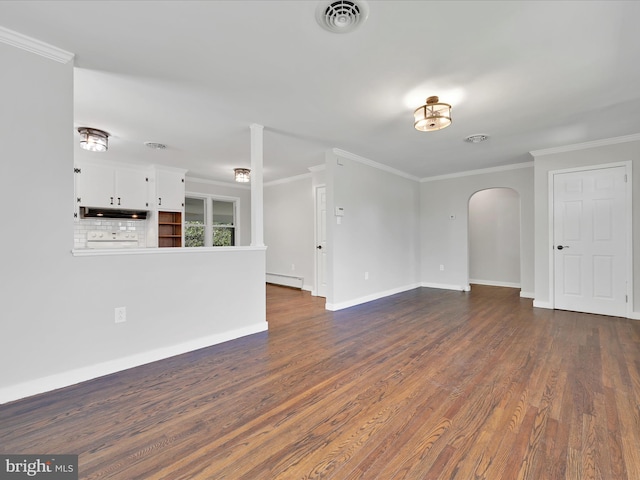 spare room with arched walkways, ornamental molding, baseboards, visible vents, and dark wood-style floors