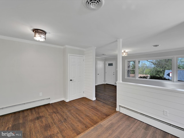 spare room with crown molding, dark wood-style flooring, visible vents, and a baseboard radiator
