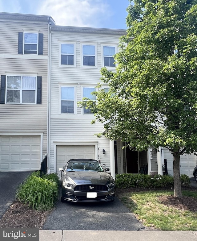 view of property with a garage and driveway