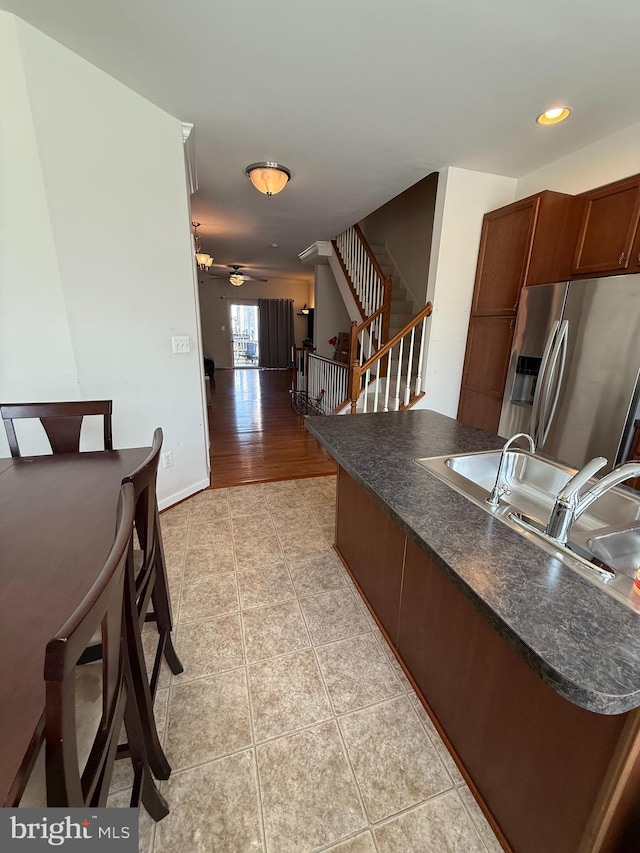 2907 Chinkapin Oak Ln Unit 245, Woodbridge, VA 22191 - kitchen featuring stainless steel fridge with ice dispenser, dark countertops, a sink, light tile patterned floors, and a ceiling fan