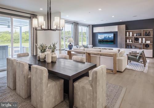 dining space featuring recessed lighting, light wood-style flooring, and a chandelier