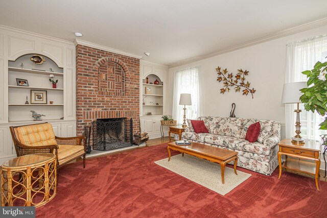 living room with crown molding, built in shelves, carpet, and a fireplace