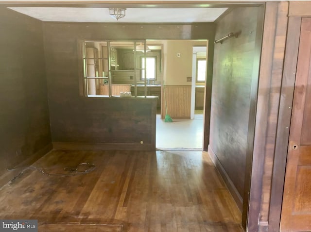 interior space featuring wood-type flooring and wainscoting