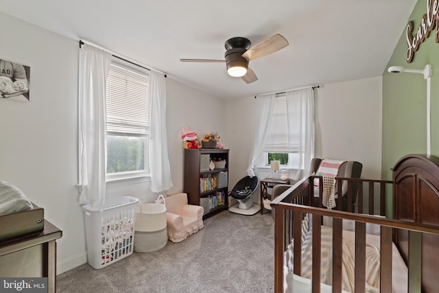 bedroom with baseboards, carpet flooring, a ceiling fan, and multiple windows