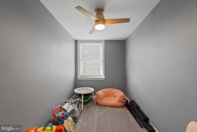 rec room with carpet floors and a ceiling fan