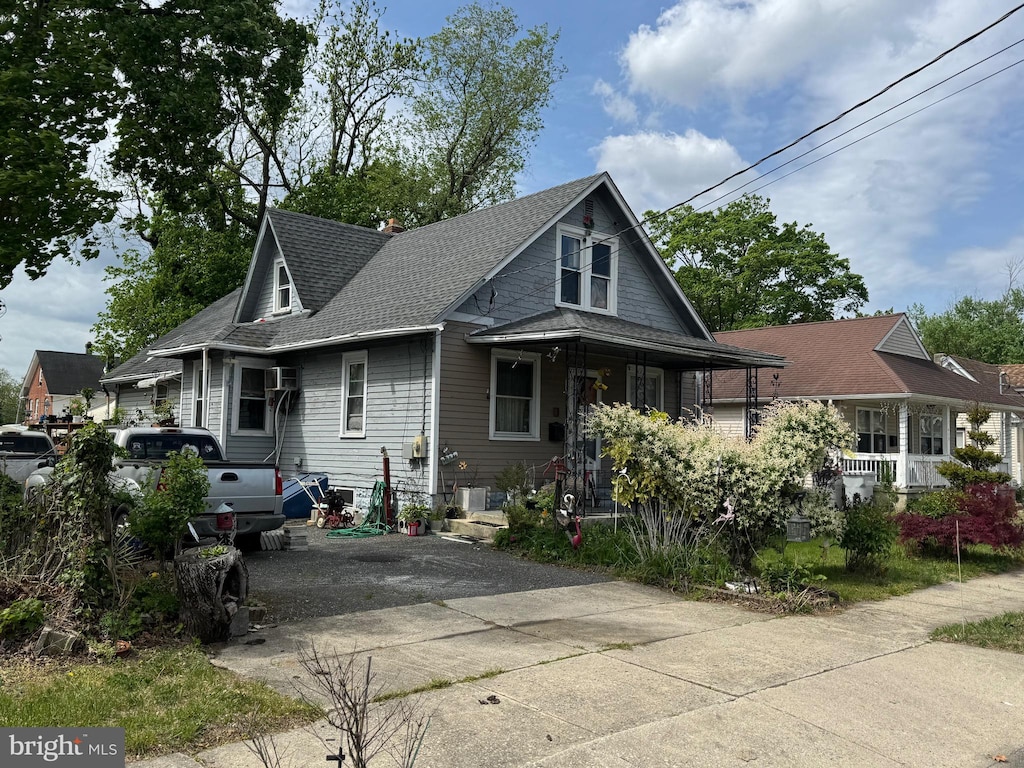bungalow-style house with concrete driveway and roof with shingles