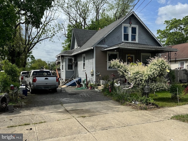 bungalow with roof with shingles and driveway