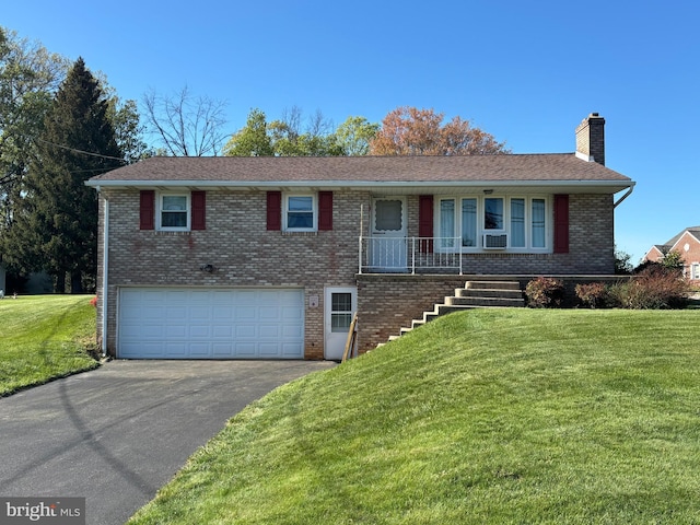 single story home featuring an attached garage, a front lawn, driveway, and a chimney