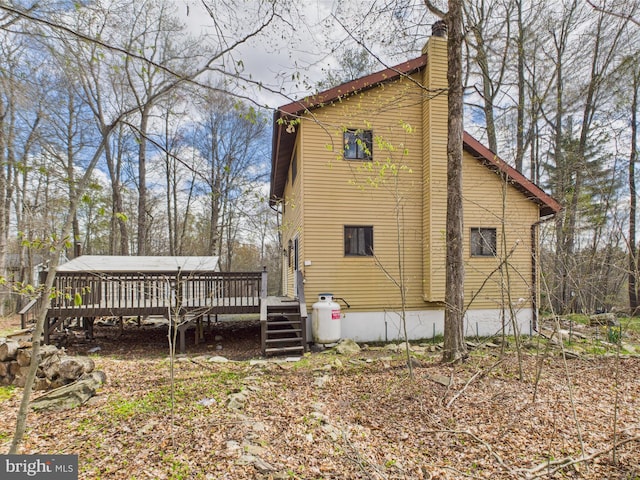 4105 Wilcox Ct, Pocono Lake, PA 18347 - rear view of house with a deck and a chimney