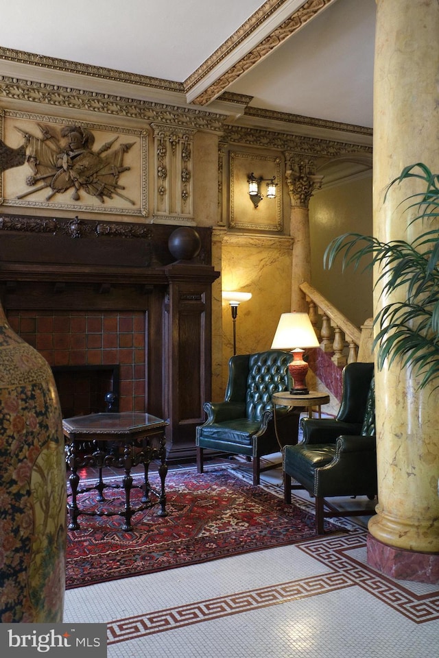 interior space with carpet floors, ornamental molding, and a tiled fireplace