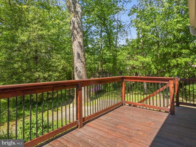 wooden terrace with a fenced backyard