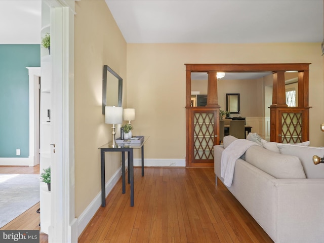 living room with wood-type flooring and baseboards