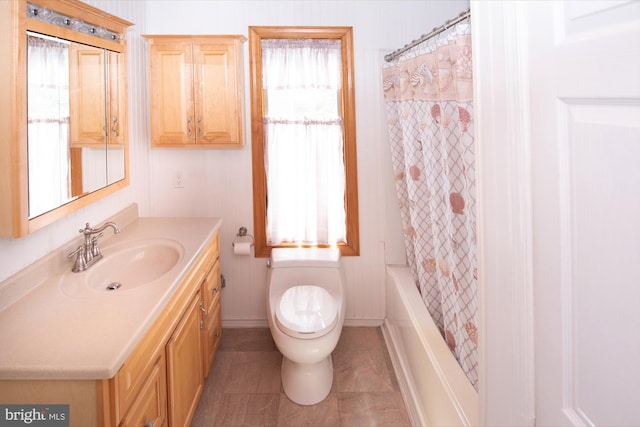 bathroom with tile patterned flooring, vanity, toilet, shower / bath combination with curtain, and baseboards