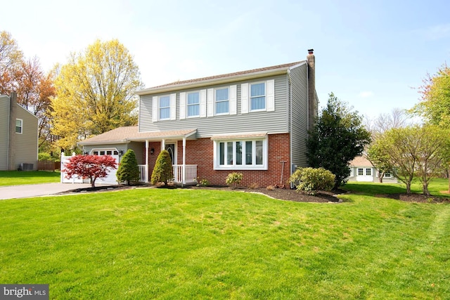 view of front of house with a garage, a front lawn, a chimney, brick siding, and concrete driveway