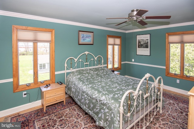 bedroom featuring crown molding, baseboards, and multiple windows