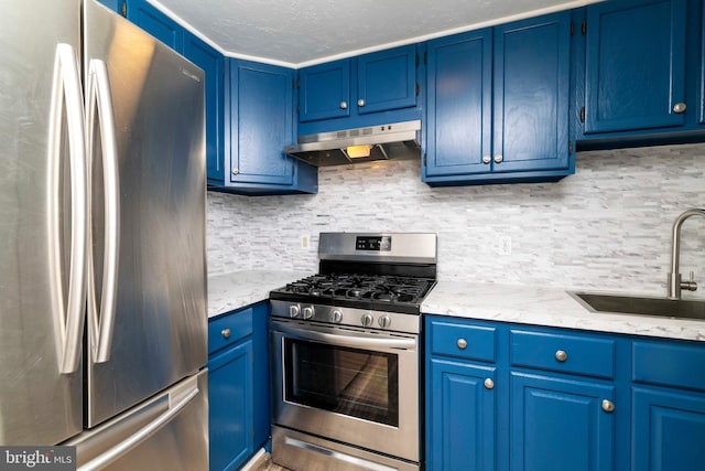 1414 Simpson St, Marcus Hook, PA 19061 - kitchen featuring under cabinet range hood, appliances with stainless steel finishes, and blue cabinets