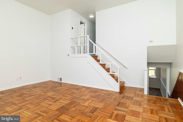 1414 Simpson St, Marcus Hook, PA 19061 - interior space featuring baseboards, visible vents, stairway, and a towering ceiling