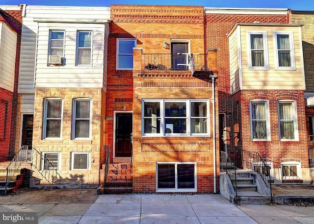 view of front of house with a balcony and entry steps