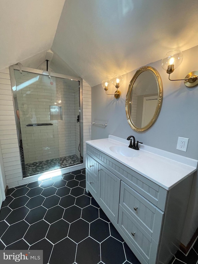 bathroom with vanity, tile patterned floors, vaulted ceiling, and a shower stall