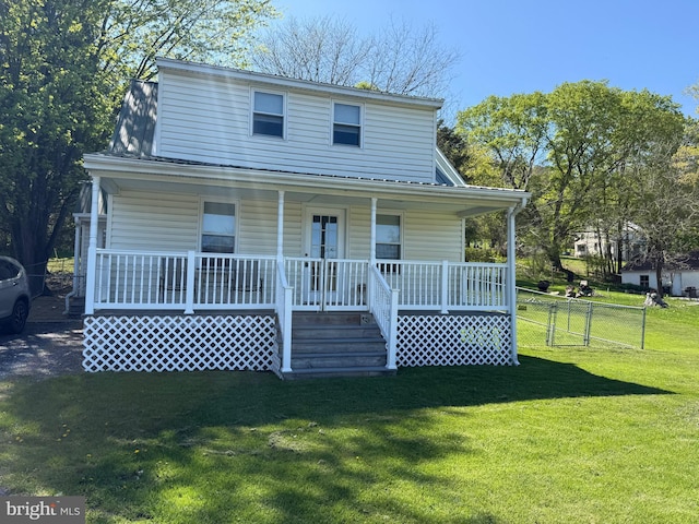view of front of property featuring a porch, fence, and a front yard