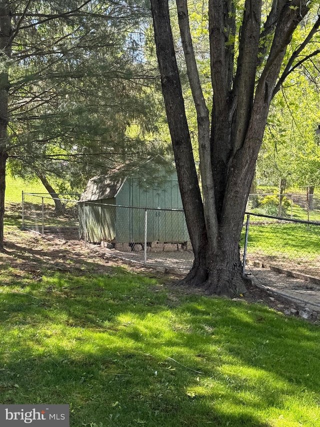 view of yard with an outdoor structure and fence