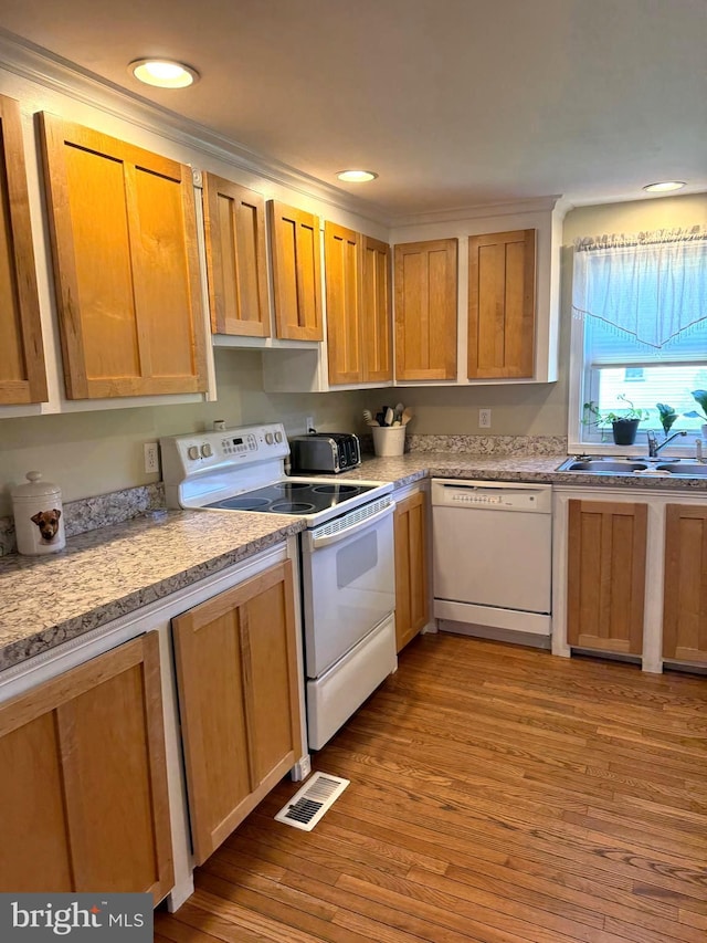 kitchen featuring recessed lighting, white appliances, wood finished floors, and visible vents