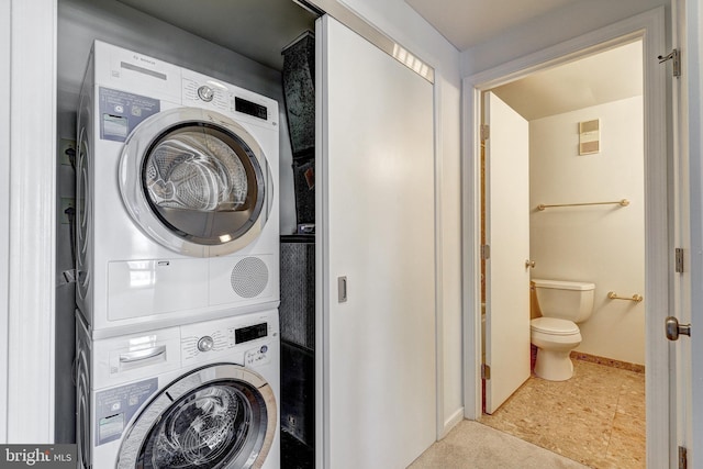 250 President St Unit 308, Baltimore, MD 21202 - clothes washing area featuring laundry area, stacked washer and dryer, baseboards, and visible vents