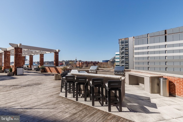250 President St Unit 308, Baltimore, MD 21202 - view of patio featuring exterior kitchen, a grill, a pergola, and outdoor wet bar
