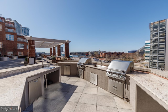250 President St Unit 308, Baltimore, MD 21202 - view of patio / terrace with area for grilling, exterior kitchen, a sink, and a view of city